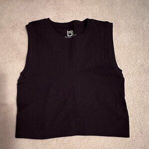 Blanc Noir perforated solid mid-drift top.